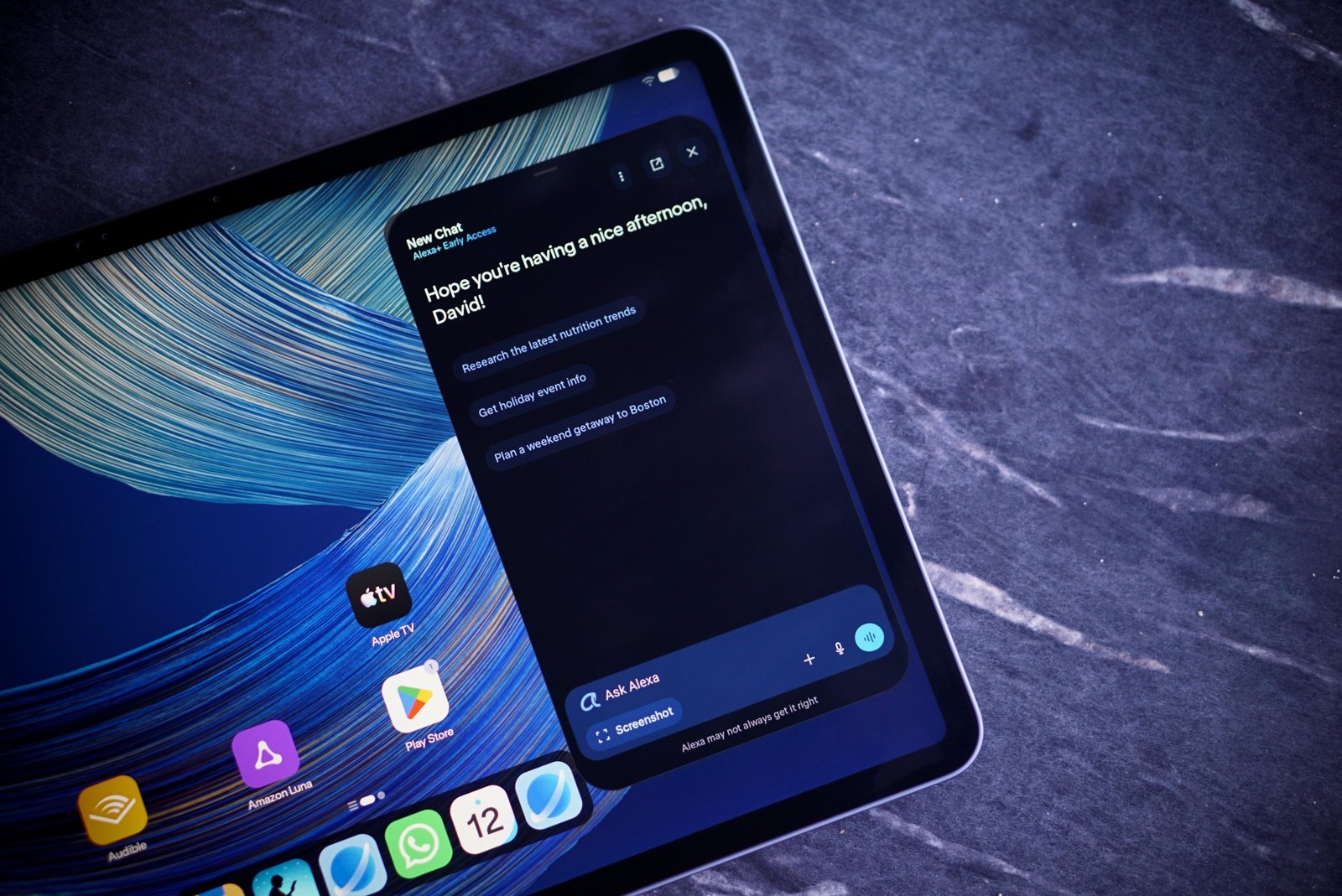 A photo of a tablet with a widget open showing an Alexa conversation.
