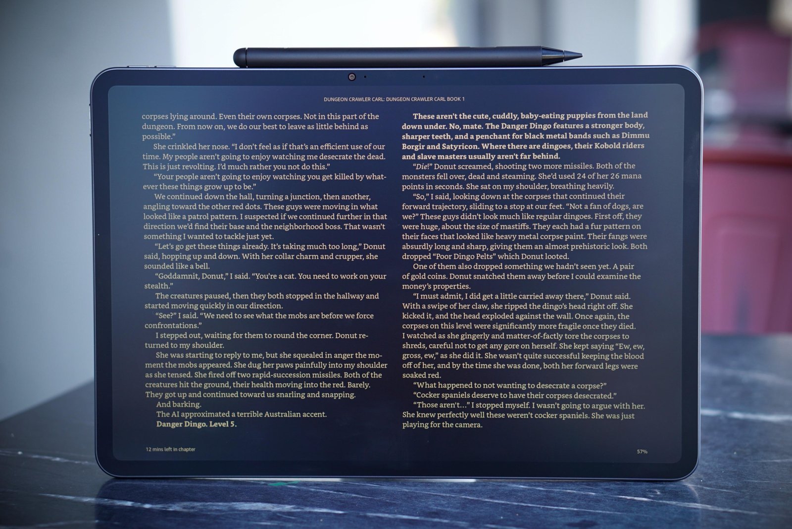 An Alexa Tablet propped up on a table, showing a page from a book.
