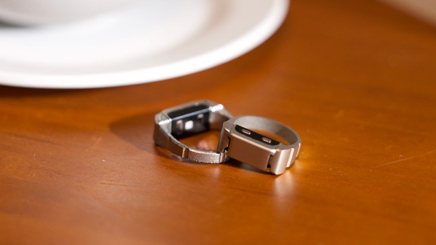 Two Alloop rings on a wood surface.