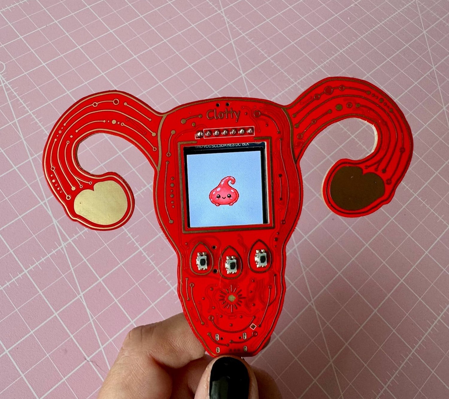 Uterus shaped computer device showing tiny sprite character on screen