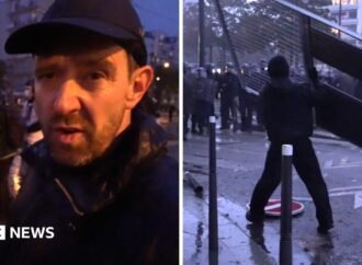 Fireworks and tear gas as protesters and riot police clash in Paris