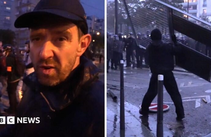 Fireworks and tear gas as protesters and riot police clash in Paris