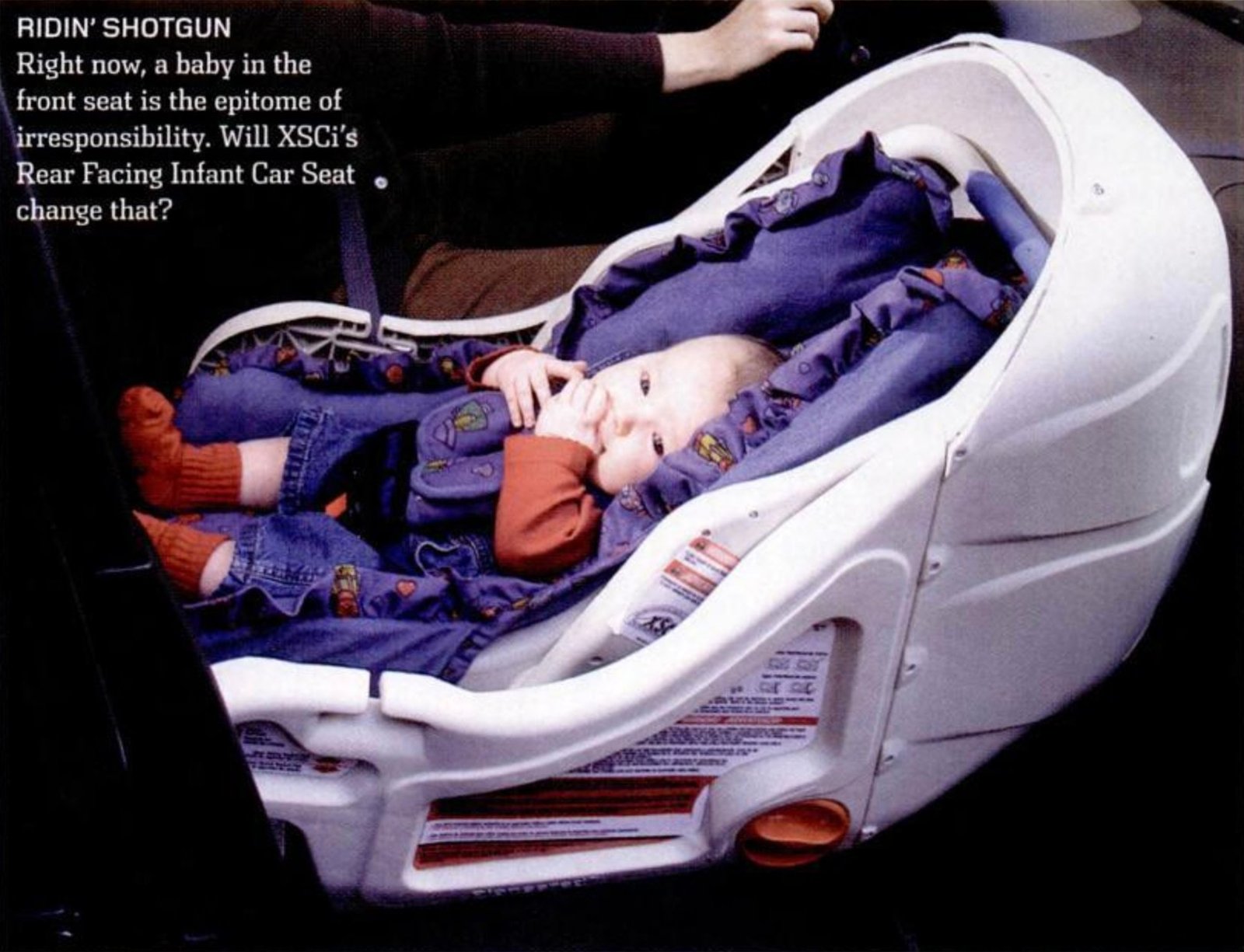 Futuristic car seat from 2002 shows baby in front car seat.