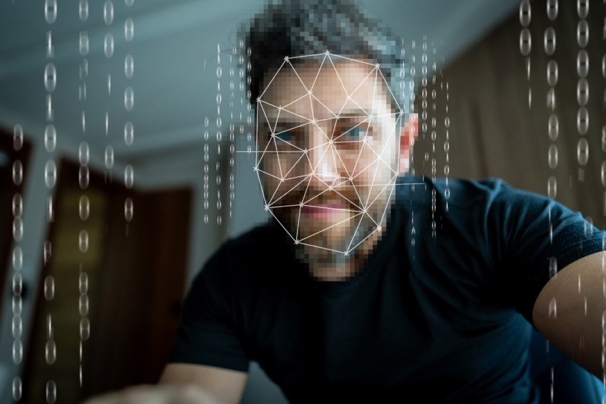 Man undergoing facial recognition scanning with digital biometric technology.