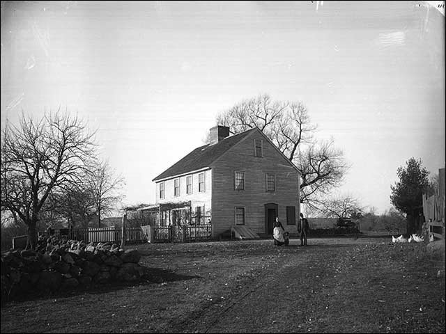 Black and white vintage photograph of old colonial house.