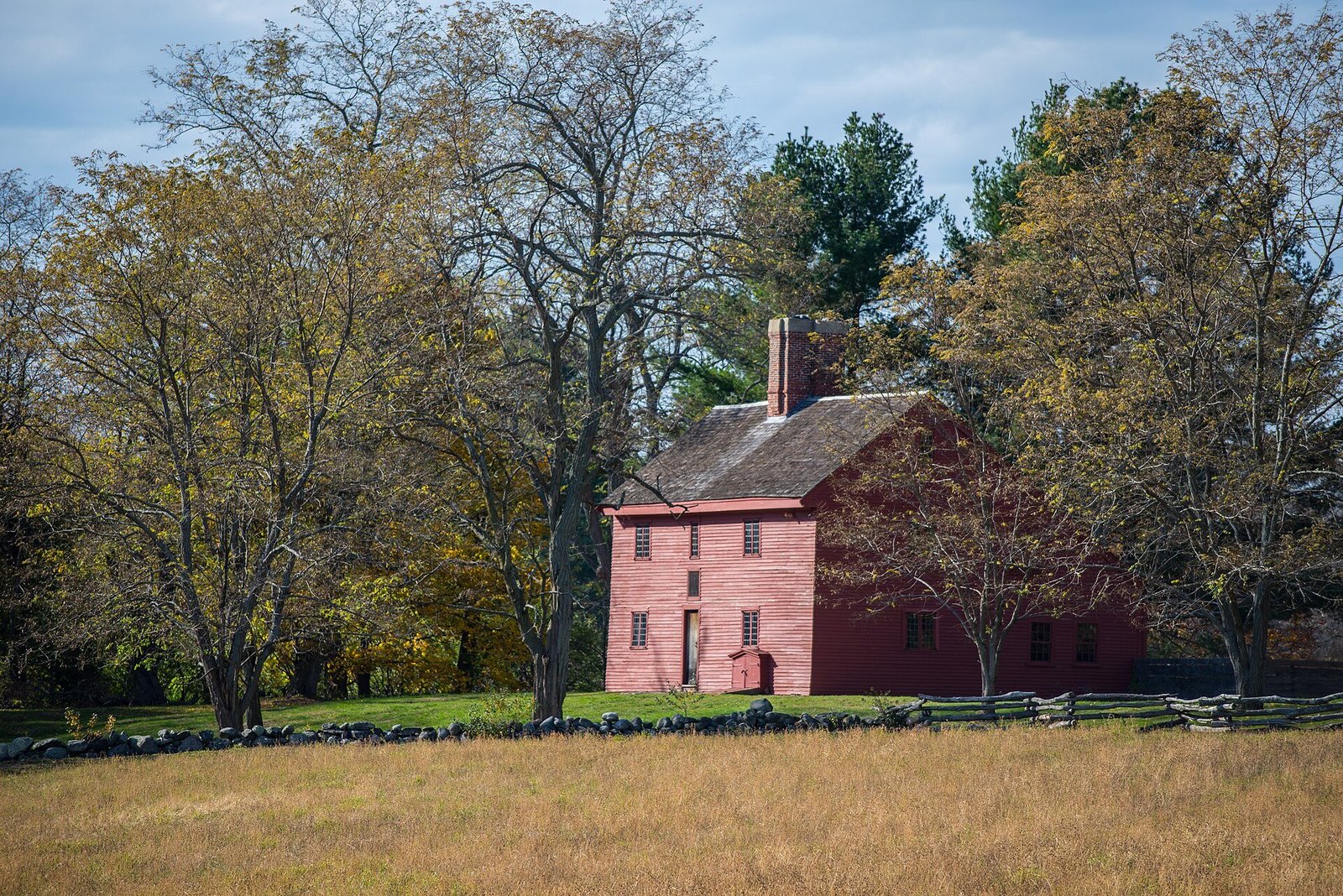Photograph of old red colonial house.