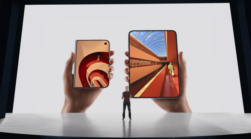 A presenter stands in front of a huge presentation screen. The screen shows an iPhone Duo folded up with its cover screen (left) compared to an unfolded Duo with its inner screen (right). Both have the same length-to-width ratio.