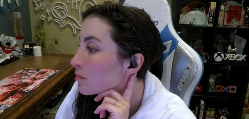 Side profile of me showing the earbuds sitting discretely over my ear and looping down over the ear canal.