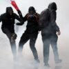 Storefronts close as police in Paris fire tear gas and water cannons on protesters