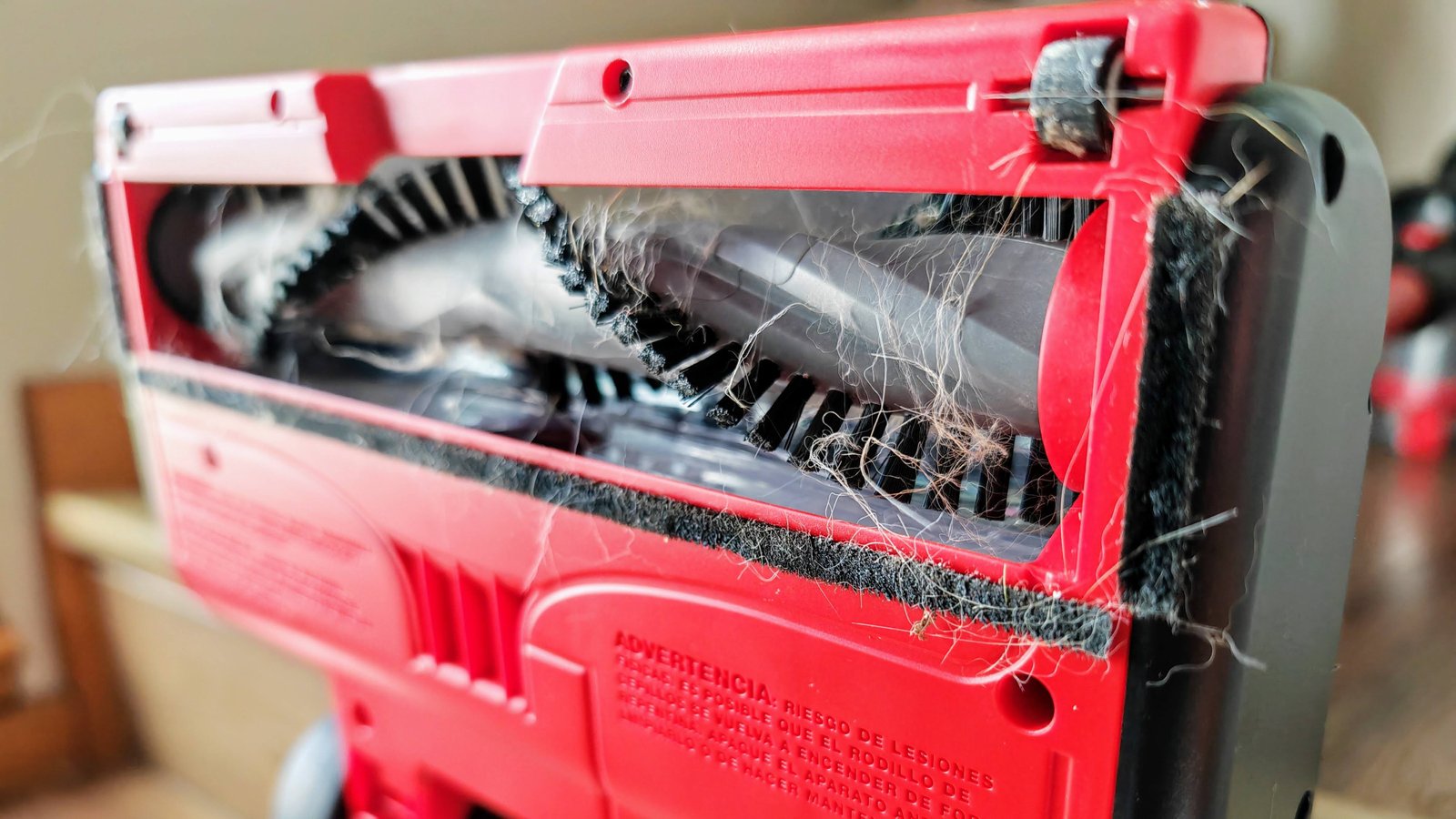 A Dirt Devil Self-Standing Cordless Stick Vacuum with hair on the brush.