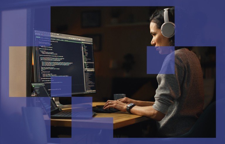 Shot through an open window, a female programmer works on a desktop computer while wearing headphones.