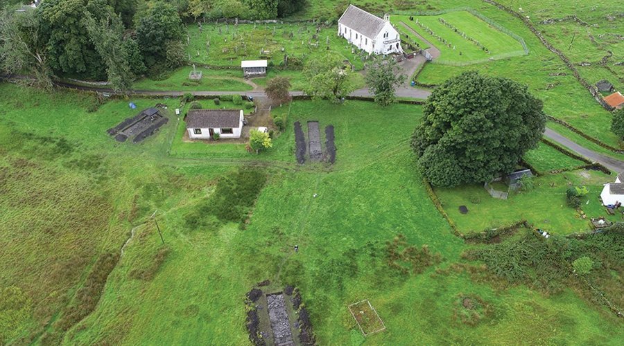 Aerial photograph of archaeological excavation in rural green Scotland.