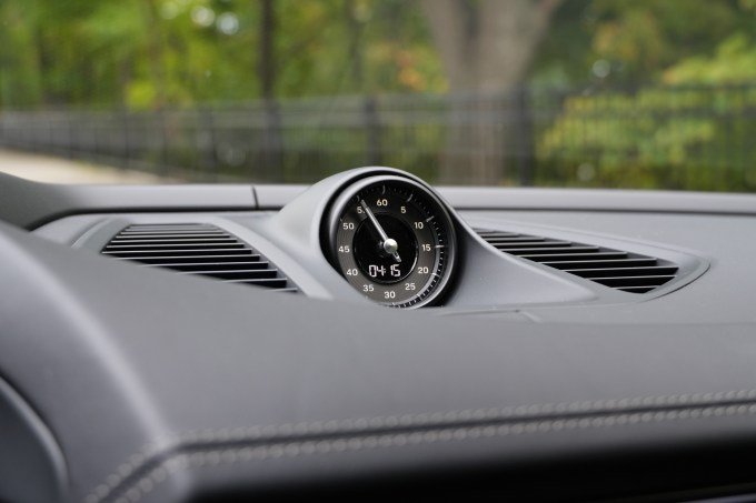A clock sits atop a dash.