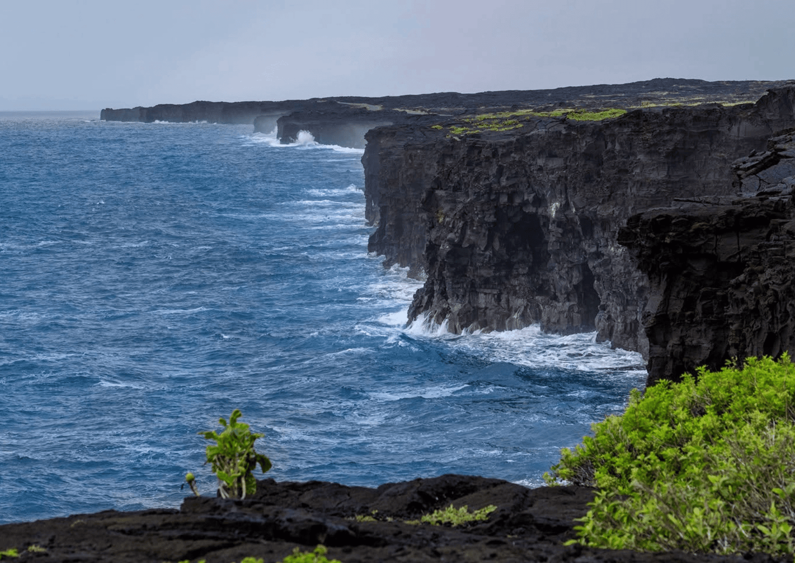 a cliff made of volcanic rock over the ocean