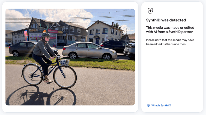 Screenshot of a tool that is determining that a photo of a woman riding a bike on a sunny day with cars and buildings in the background has been edited by AI.