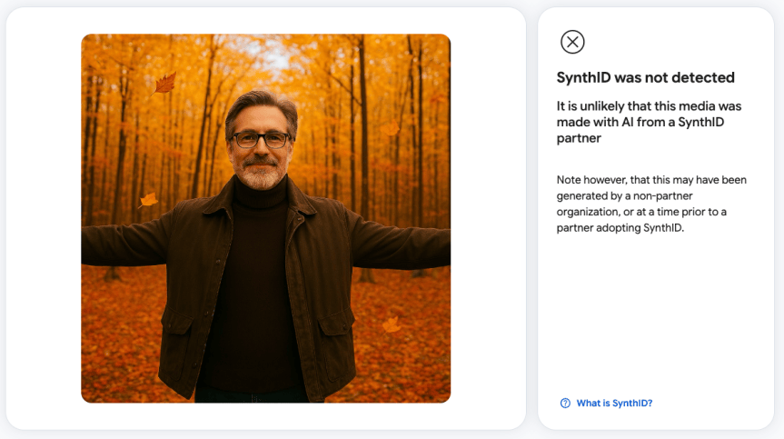 A photo of a man with arms outstretched amid fall leaves and trees appears genuine based on the lack of a SynthID tag (even though it's entirely AI-generated).