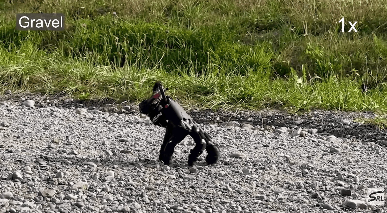 a robot shaped like a human hand walks on gravel